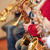 Jugendliche spielen Saxophone und Trompeten im Orchester